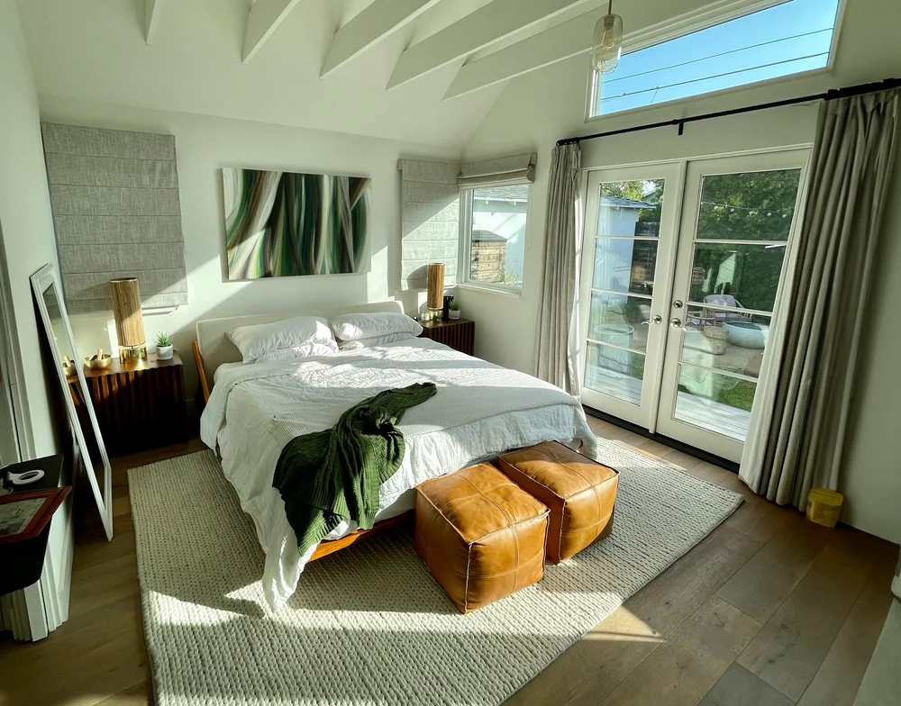 Natural light bedroom with french doors opening to private backyard