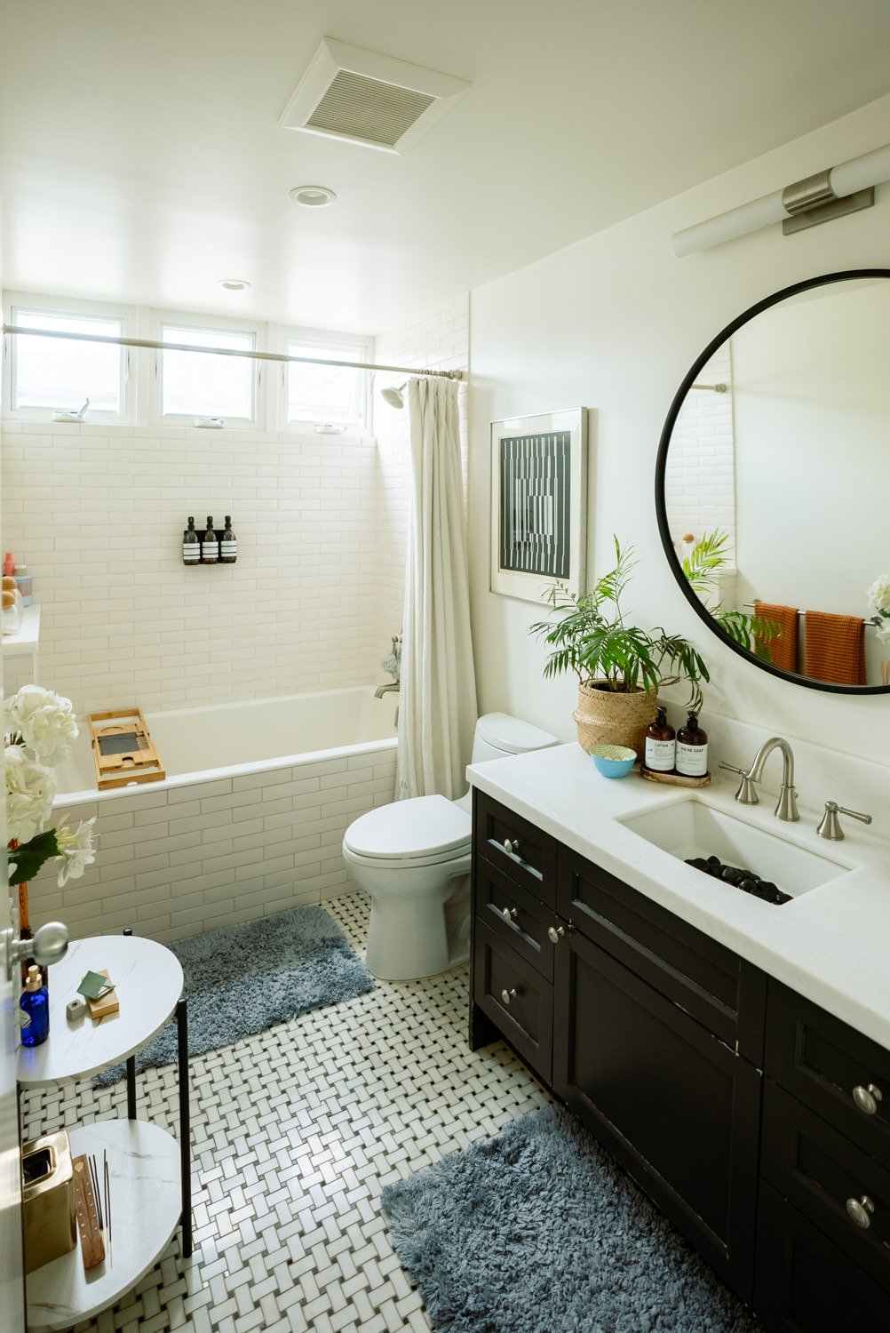 Beautifully styled bathroom with oversized tub and round mirror at the Boudoir Bungalow