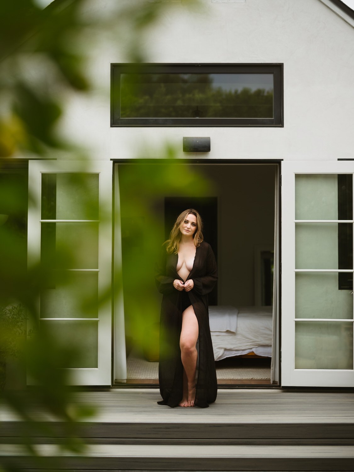 Boudoir photography in the main bedroom with private backyard french doors
