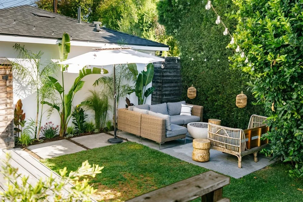 Outdoor private patio with fire pit and tropical greenery in Venice California